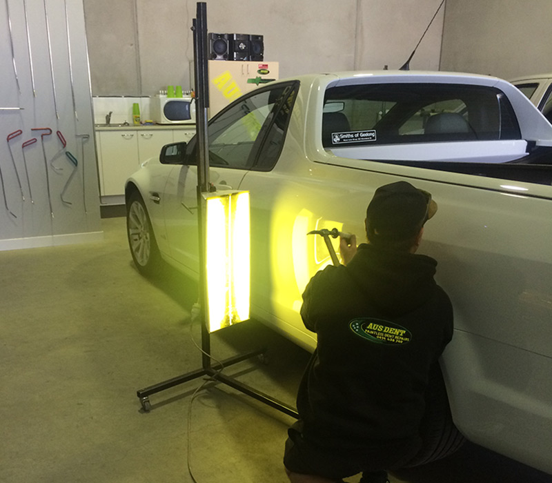 Technician performing Paintless Dent Repair